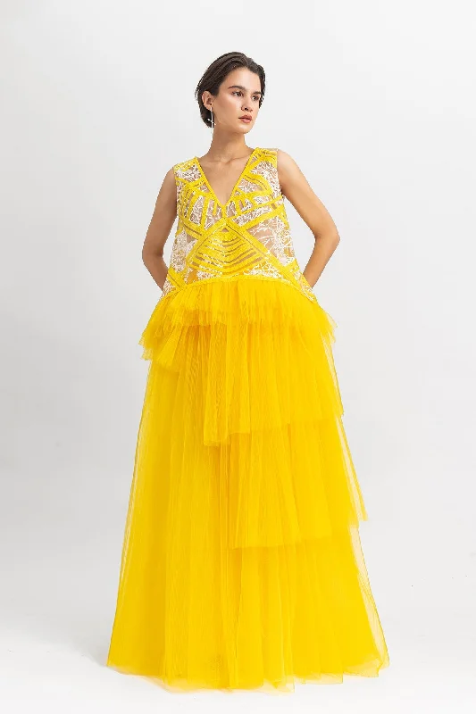 Straight cut sequin top with ruffled tulle details paired with a fully pleated wide tulle skirt velvet skirt glossy